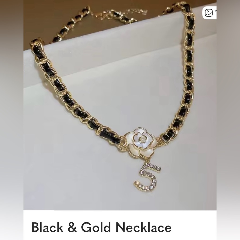 Elegant Gold and Black Necklace with Floral Charm